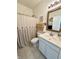 Bright bathroom featuring a vanity with a framed mirror and a shower with a buttoned shower curtain at 1119 E Main Cross St, Edinburgh, IN 46124