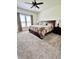 Bright bedroom with neutral carpet, ceiling fan and large window at 1119 E Main Cross St, Edinburgh, IN 46124