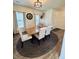 Bright dining area features wood table, seating for six, stylish chandelier, and wood-look flooring at 1119 E Main Cross St, Edinburgh, IN 46124