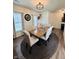 Cozy dining area features wood table, seating for six, and stylish chandelier at 1119 E Main Cross St, Edinburgh, IN 46124