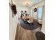 Elegant dining room featuring a modern chandelier, wood-look flooring, and bright natural light at 1119 E Main Cross St, Edinburgh, IN 46124