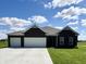 Charming brick home with three-car garage, well-manicured lawn and inviting curb appeal at 1119 E Main Cross St, Edinburgh, IN 46124