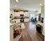 Modern kitchen with white cabinets, granite countertops, stainless steel appliances, and wood-look flooring at 1119 E Main Cross St, Edinburgh, IN 46124