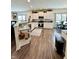 Well-lit kitchen with white cabinets, granite countertops, stainless appliances, and wood-look flooring at 1119 E Main Cross St, Edinburgh, IN 46124