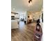 Open-concept living space with hardwood floors, modern lighting, and seamless flow to the dining and kitchen areas at 1119 E Main Cross St, Edinburgh, IN 46124