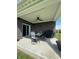 Covered patio with ceiling fan, outdoor dining set, and a grill perfect for entertaining at 1119 E Main Cross St, Edinburgh, IN 46124