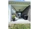 Covered patio with fan, seating and grill, overlooking a spacious yard at 1119 E Main Cross St, Edinburgh, IN 46124