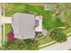 Aerial view of home's backyard with a patio, lush greenery, wooden fence, and mature landscaping at 11205 Echo Ridge Ln, Indianapolis, IN 46236