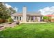 Expansive backyard boasts a covered patio, lush lawn, and mature trees, ideal for outdoor entertaining and relaxation at 11205 Echo Ridge Ln, Indianapolis, IN 46236