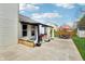 Charming backyard patio offers an outdoor living space with curtains, a dining set, and a grill for easy entertaining at 11205 Echo Ridge Ln, Indianapolis, IN 46236