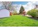 Spacious backyard with mature trees, outdoor dining set, playset, and shed offers plenty of room for recreation and storage at 11205 Echo Ridge Ln, Indianapolis, IN 46236