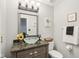 Charming half bath with designer fixtures, unique bowl sink, and decorative accents at 11205 Echo Ridge Ln, Indianapolis, IN 46236