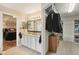 Bathroom with double vanity, granite counters, and a view into the bedroom and walk-in closet at 11205 Echo Ridge Ln, Indianapolis, IN 46236