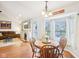 Inviting dining area with large windows, a wooden table set, and a cozy living space in the background at 11205 Echo Ridge Ln, Indianapolis, IN 46236