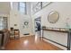 Bright and airy foyer with high ceilings, laminate floors, and a view of the staircase and adjacent living area at 11205 Echo Ridge Ln, Indianapolis, IN 46236