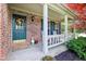 Inviting front porch with white rocking chairs and a welcoming wreath, adding to the home's curb appeal and charm at 11205 Echo Ridge Ln, Indianapolis, IN 46236