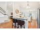 Open-concept design with a breakfast bar featuring granite countertops, seamlessly connecting the kitchen and living areas at 11205 Echo Ridge Ln, Indianapolis, IN 46236