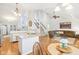 Open-concept living area showcases a kitchen with granite countertops and a comfortable seating area with a brown sofa at 11205 Echo Ridge Ln, Indianapolis, IN 46236