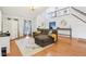 Spacious living room featuring high ceilings, a staircase, and large windows, creating a bright and airy atmosphere at 11205 Echo Ridge Ln, Indianapolis, IN 46236