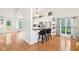 Bright open-concept kitchen and living space with white cabinets and a kitchen island at 11205 Echo Ridge Ln, Indianapolis, IN 46236