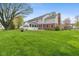 Spacious backyard with a firepit and view of the house's exterior at 11469 Burkwood Dr, Carmel, IN 46033