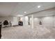 Open basement space with carpeted floors and access to multiple rooms at 11469 Burkwood Dr, Carmel, IN 46033