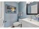 Stylish half bath with framed mirror, sleek fixtures, and decorative accents at 11469 Burkwood Dr, Carmel, IN 46033