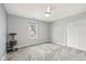 Bright bedroom with a large window, a ceiling fan, and a double-door closet at 11469 Burkwood Dr, Carmel, IN 46033