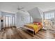 Bright bedroom with wooden floors, sloped ceilings, and a ceiling fan at 11469 Burkwood Dr, Carmel, IN 46033