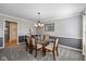 Dining room with carpet, traditional chandelier, and two-tone wall at 11469 Burkwood Dr, Carmel, IN 46033