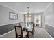 Dining room with carpet, modern chandelier, and light gray walls at 11469 Burkwood Dr, Carmel, IN 46033