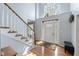Bright foyer featuring hardwood floors, staircase, and a front door with decorative glass at 11469 Burkwood Dr, Carmel, IN 46033