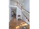 Hallway with wood floors, a staircase, and a view into the kitchen at 11469 Burkwood Dr, Carmel, IN 46033