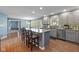 Open kitchen with a large island, barstool seating, and stainless steel appliances at 11469 Burkwood Dr, Carmel, IN 46033