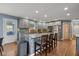 Bright kitchen featuring gray cabinets, a large island, and stainless steel appliances at 11469 Burkwood Dr, Carmel, IN 46033
