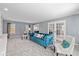Inviting living room with large windows, plush seating, and French doors at 11469 Burkwood Dr, Carmel, IN 46033