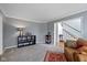 Cozy living room with carpet, a decorative rug, and access to the foyer at 11469 Burkwood Dr, Carmel, IN 46033