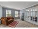 Cozy living room features neutral walls, plush carpet, and decorative furnishings at 11469 Burkwood Dr, Carmel, IN 46033