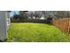Backyard features a well-maintained lawn and a sturdy wooden privacy fence at 11651 Congressional Ln, Indianapolis, IN 46235