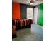 Colorful bedroom with geometrically patterned floors, a window, and bright walls at 11651 Congressional Ln, Indianapolis, IN 46235