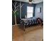 Bedroom features unique wall art, a window with natural light, and modern fixtures at 11651 Congressional Ln, Indianapolis, IN 46235