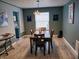 Elegant dining room with a wooden table set, modern lighting, and stylish wall art at 11651 Congressional Ln, Indianapolis, IN 46235