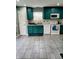 Functional kitchen featuring teal cabinets, modern appliances, and durable tile flooring at 11651 Congressional Ln, Indianapolis, IN 46235