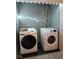 Convenient laundry room with modern Samsung washer and dryer units, accented by decorative lighting at 11651 Congressional Ln, Indianapolis, IN 46235
