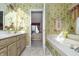 Inviting bathroom with a soaking tub, wallpaper, and updated vanity at 11697 Whisper Bay Ct, Carmel, IN 46033