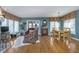 Sunlit dining area with hardwood floors, chandelier, and large windows at 11697 Whisper Bay Ct, Carmel, IN 46033