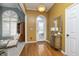 Elegant foyer featuring hardwood floors, decorative lighting, arched doorway, and furniture piece at 11697 Whisper Bay Ct, Carmel, IN 46033