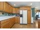 Bright kitchen with hardwood floors, cabinets, and adjacent appliances at 11697 Whisper Bay Ct, Carmel, IN 46033