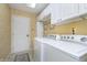 Functional laundry room with washer, dryer, white cabinets and a sink at 11697 Whisper Bay Ct, Carmel, IN 46033