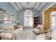 Bright living room with neutral furnishings, vaulted ceilings, arched windows, and decorative trim at 11697 Whisper Bay Ct, Carmel, IN 46033